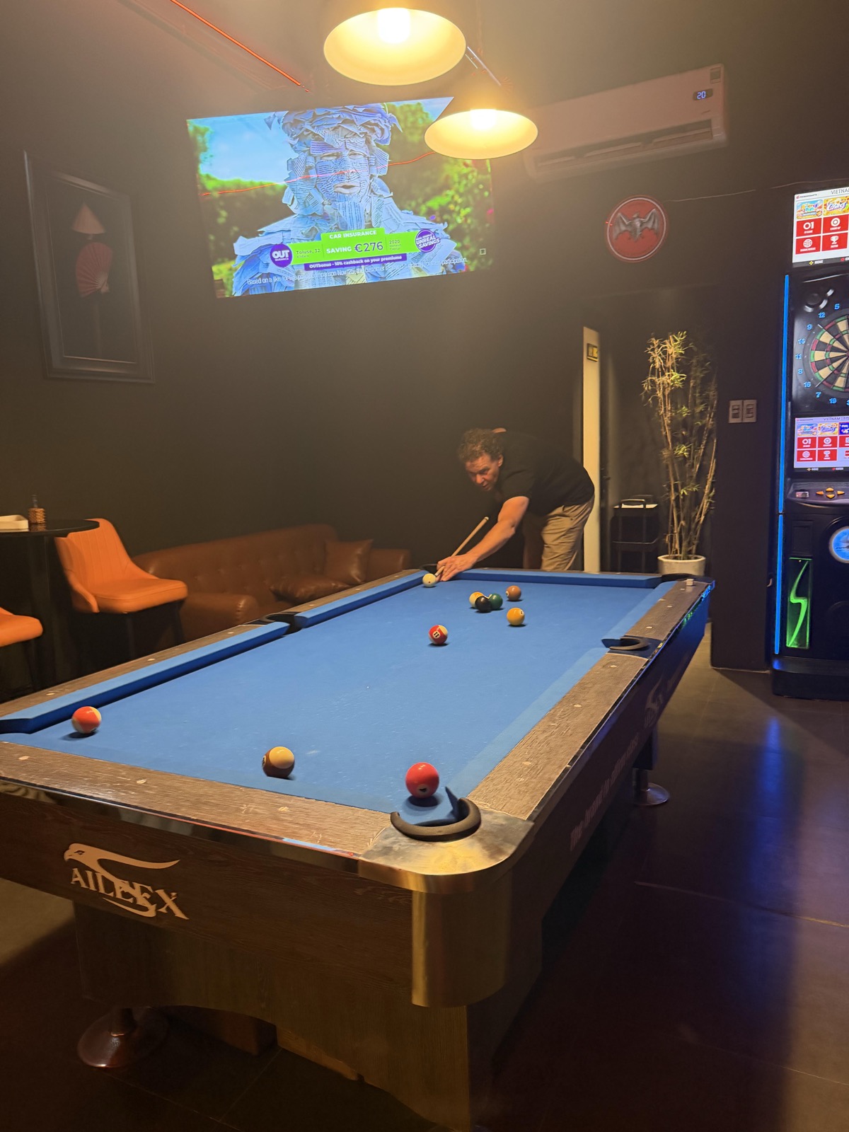Friends watching live sports at The Huddle, a pool and darts bar in District 1